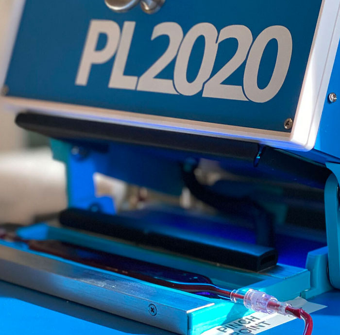 Close up look at a blue PL 2020 program machine.